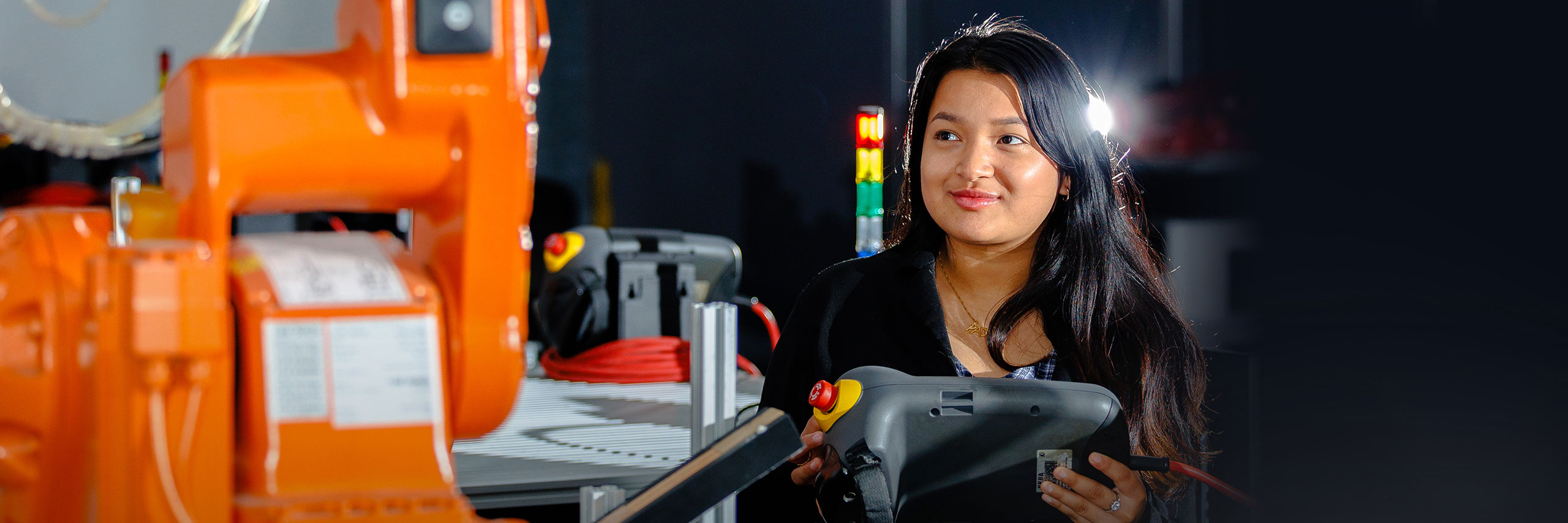 Factory worker holding an equipament.